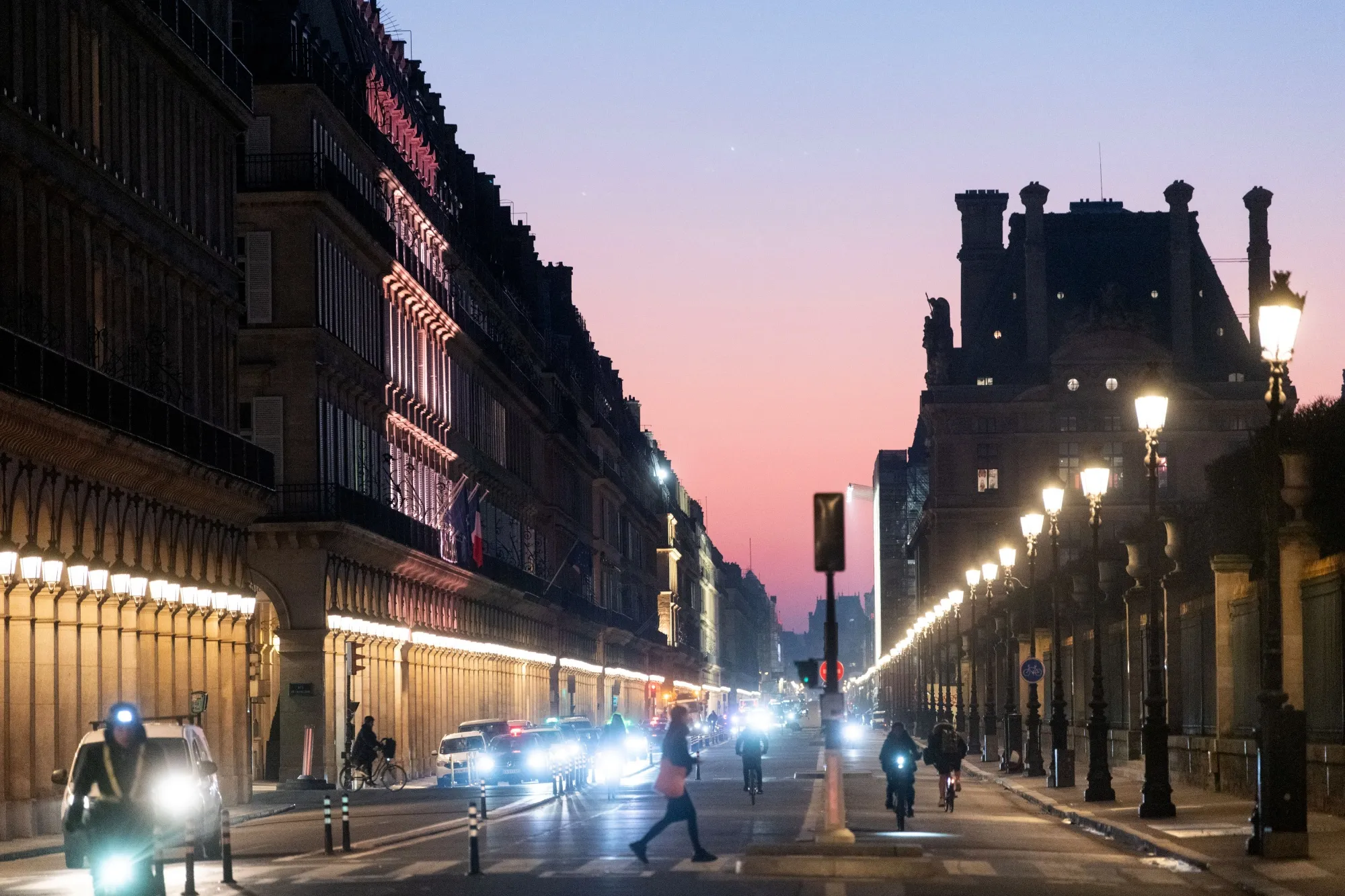 Commuters at Rivoli Street during sunrise in Paris on Jan. 24.