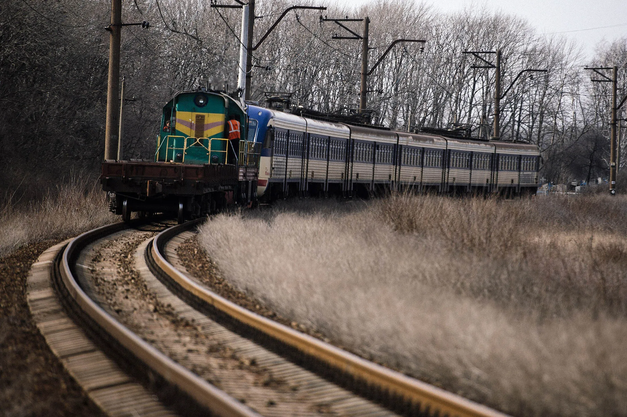 A train moves along the track near the town of Vuhlehirsk.