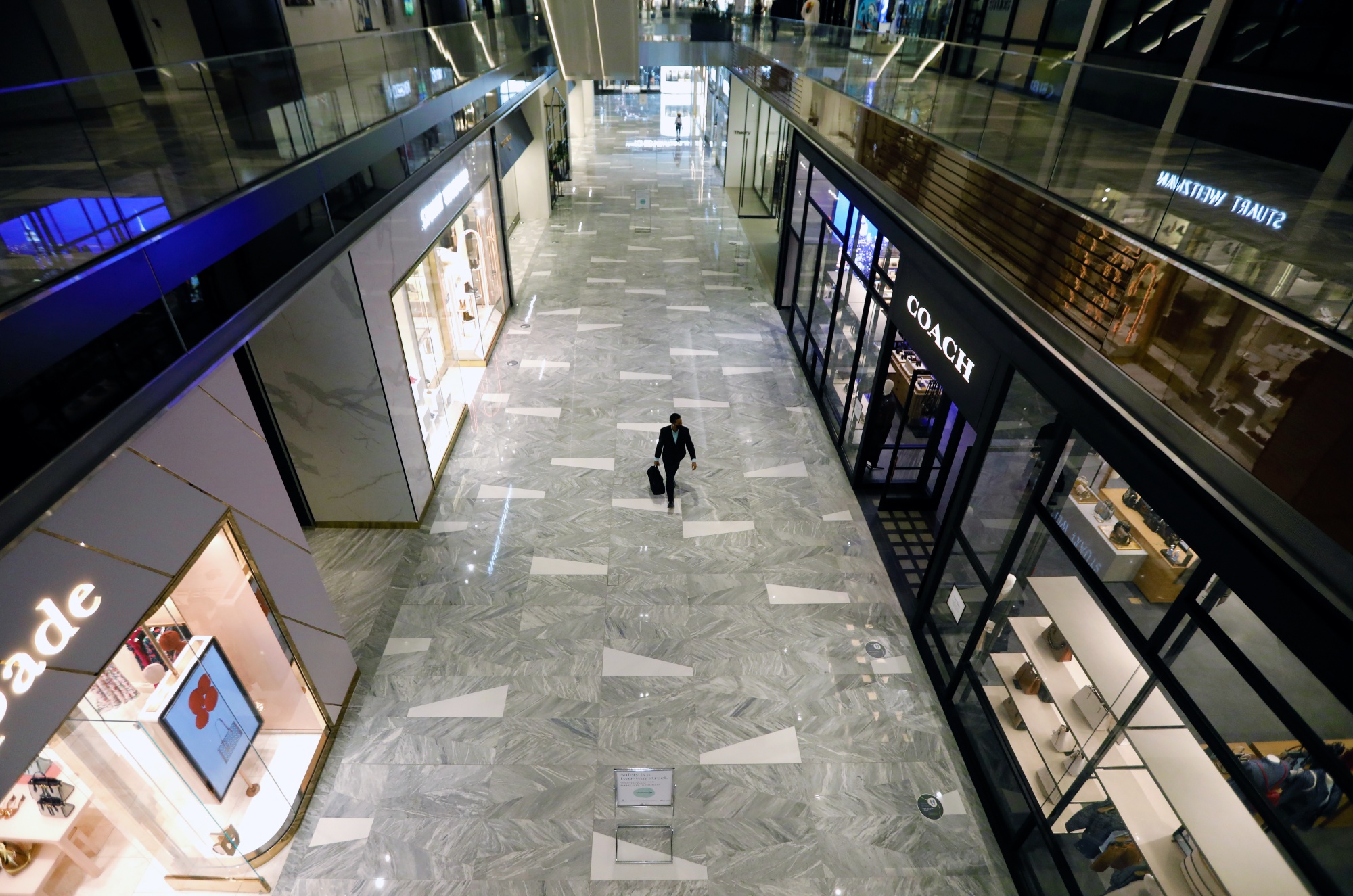 A shopper walks through the Shops & Restaurants at Hudson Yards mall in New York.