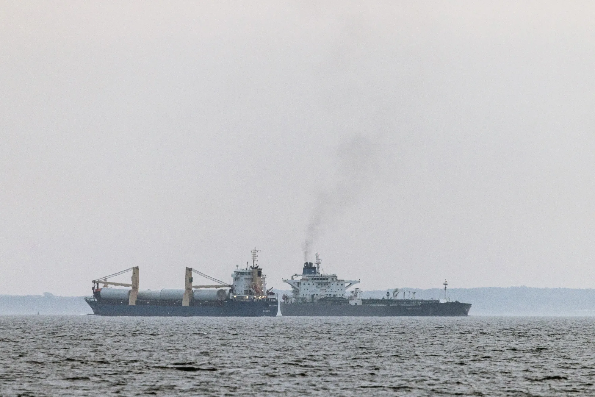 The shadow fleet tanker Turbo Voyager, right, passes a cargo vessel in the Great Belt of Denmark in 2024.
