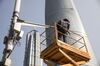 A man stands on an elevated platform while performing maintenance work on a surveillance camera in front of the Shanghai Tower, right, and the Jin Mao Tower in the Lujiazui Financial District in Shanghai, China, on Monday, Feb. 26, 2018. Xi Jinping's decision to cast aside China's presidential term limits is stoking concern he also intends to shun international rules on trade and finance, even as he champions them on the world stage.