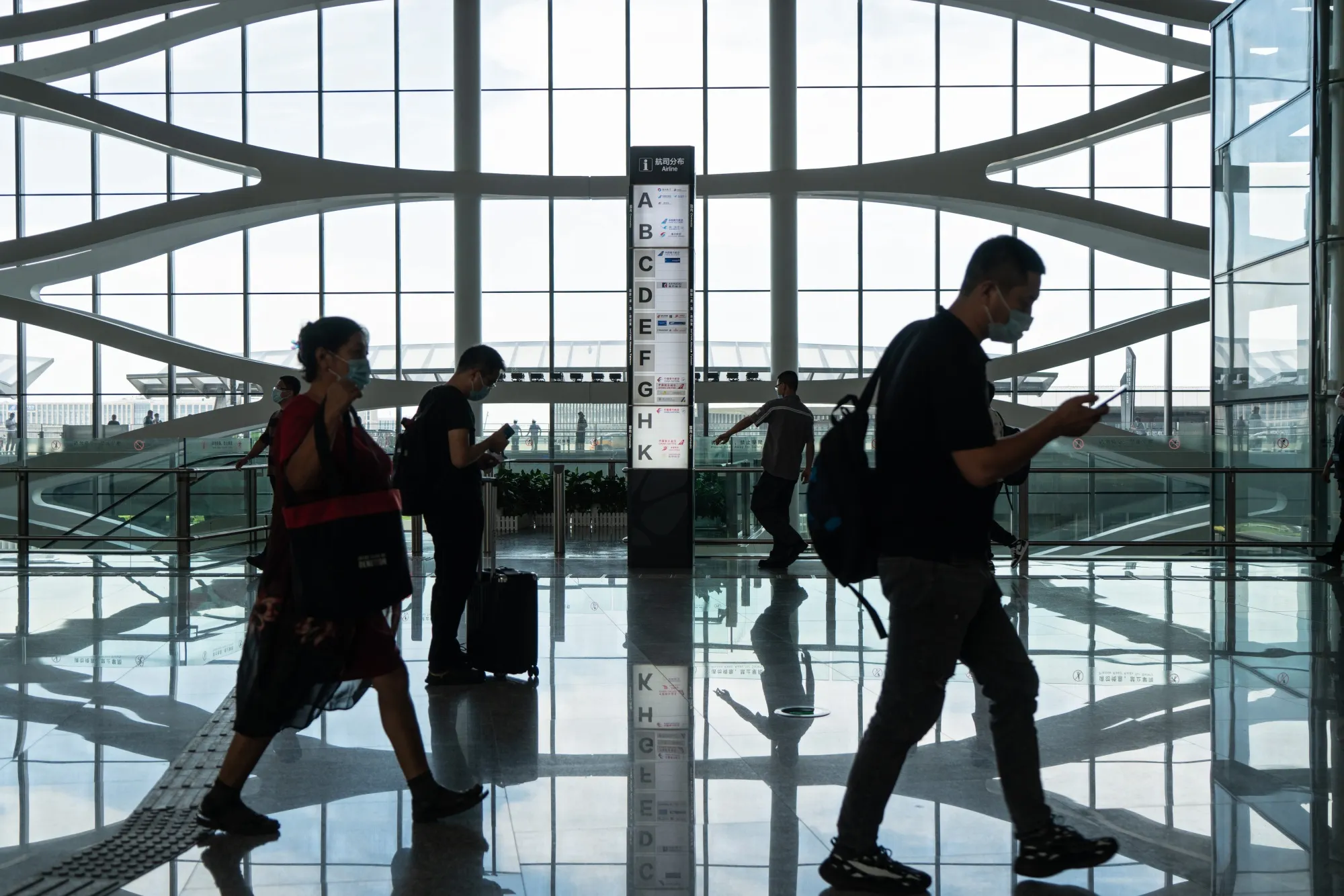 People walk through Beijing Daxing International Airport in Beijing on Aug. 25.