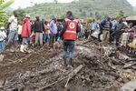 Rescuers from the Uganda Red Cross Society attend the scene of a landslide in Kasika village, Kasese district, in southwestern Uganda Wednesday, Sept. 7, 2022. The landslide triggered by heavy rain in the remote part of southwestern Uganda has killed at least 15 people, according to the Uganda Red Cross. (Uganda Red Cross Society via AP)