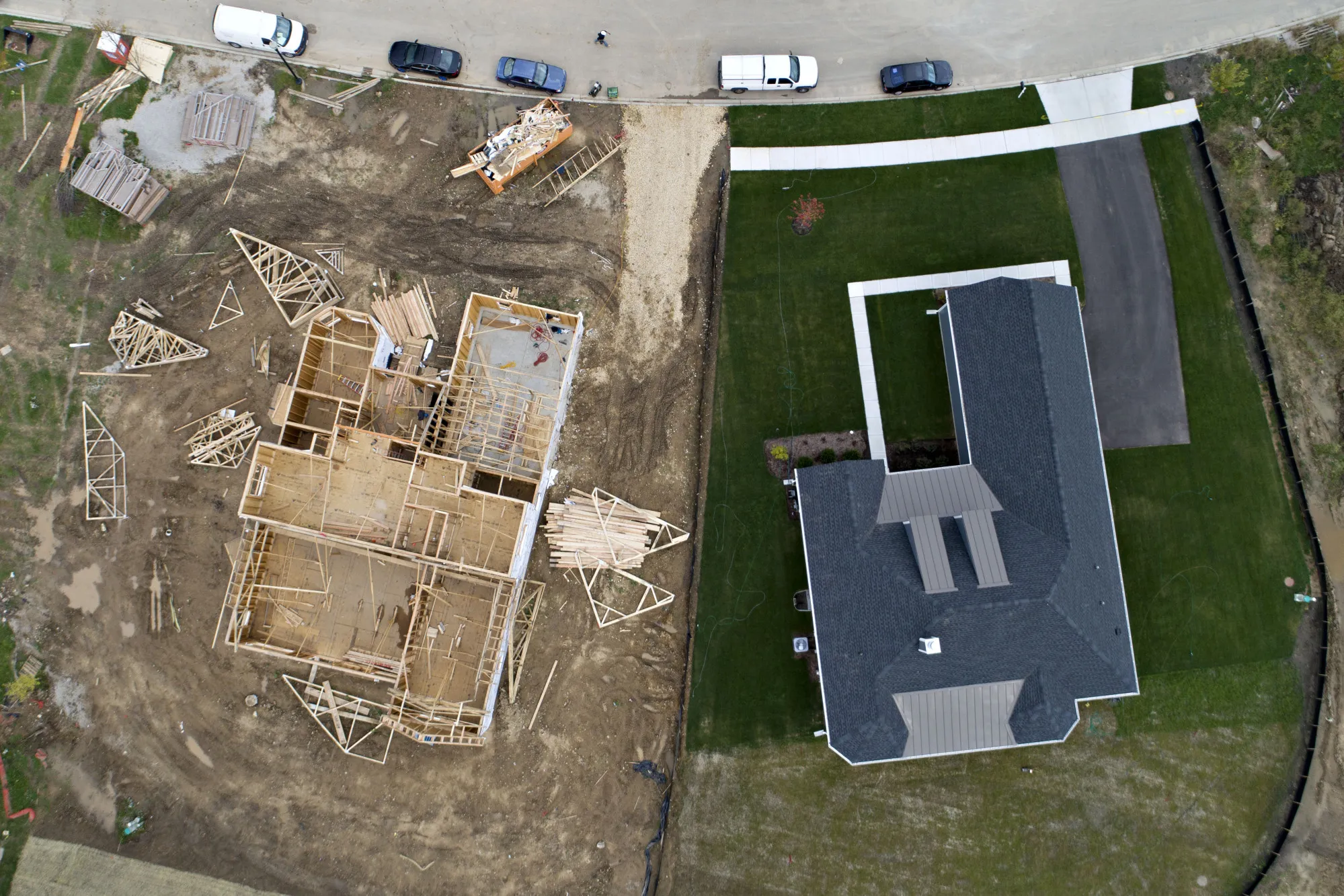 A house under construction stands next to a completed home&nbsp;taken over Elgin, Illinois, U.S.