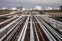 Oil transportation pipes and storage tanks stand at a oil refinery in Szazhalombatta, Hungary.