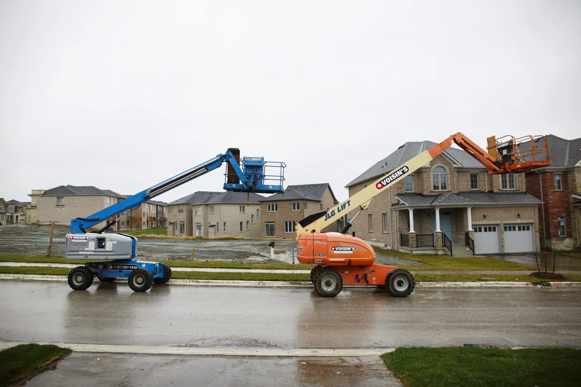 Cherry pickers sit in front of homes under construction in East Gwillimbury, Ontario, Canada, on Friday, Nov. 2, 2018. STCA Canada is scheduled to release new housing price figures on Dec. 13.