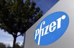 A Pfizer Inc. logo sits on a sign outside the company's research center in Cambridge, U.K., on Thursday, Sept. 26, 2013. 