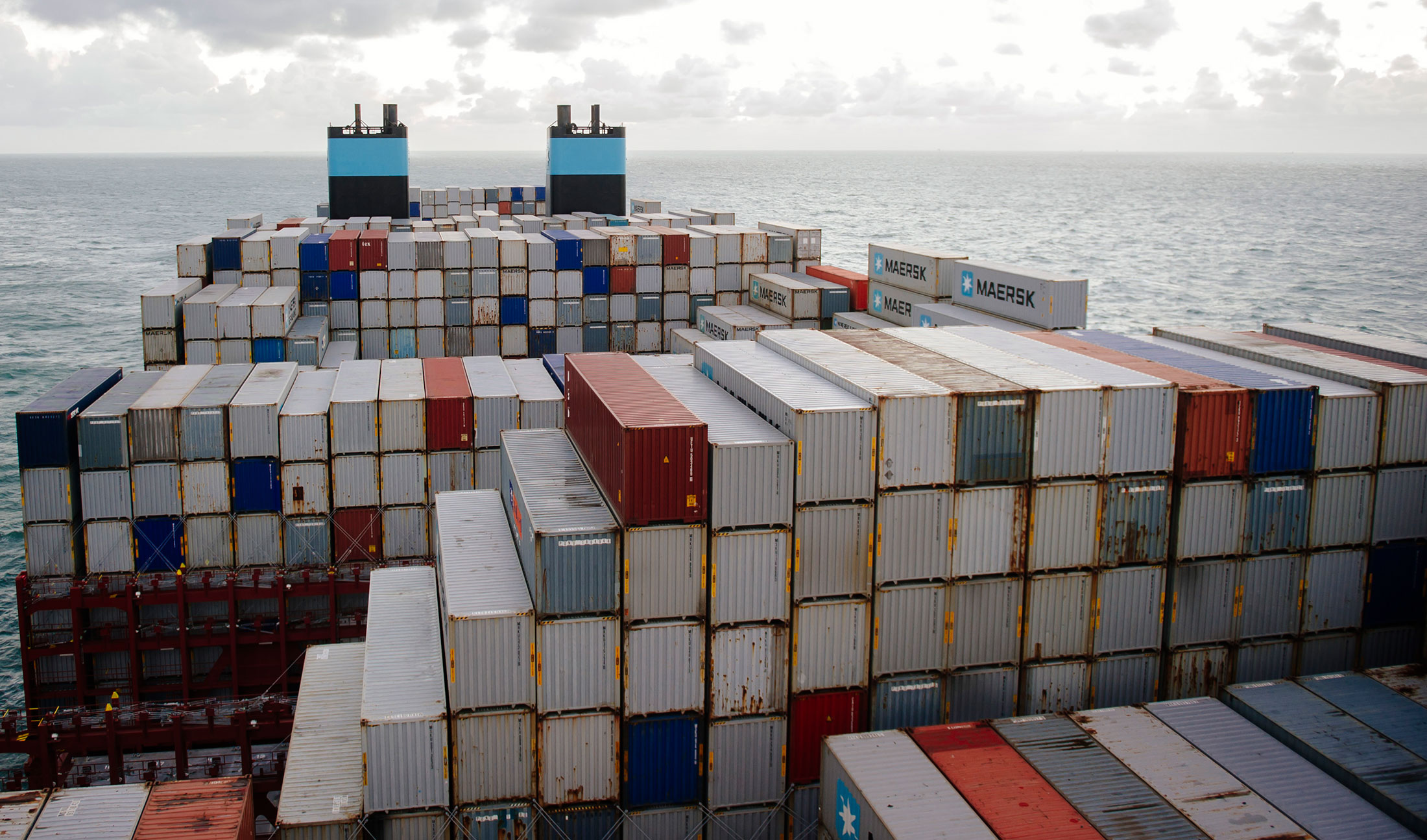 Shipping containers stand aboard the Maersk Mc-Kinney Moeller Triple-E Class container ship, operated by A.P. Moeller-Maersk A/S, as it sails on the North Sea between Rotterdam in the Netherlands and Bremerhaven, Germany, on Monday, Nov. 11, 2013. A.P. Moeller-Maersk A/S's container-shipping line, the world's largest, reported an 11 percent increase in third-quarter profit after cost cuts countered a decline in freight rates.
