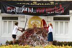 Protesters throw red paint on a heap of stationery and bamboo canes during a “Bad Student” demonstration outside the Ministry of Education in Bangkok on Jan. 16.