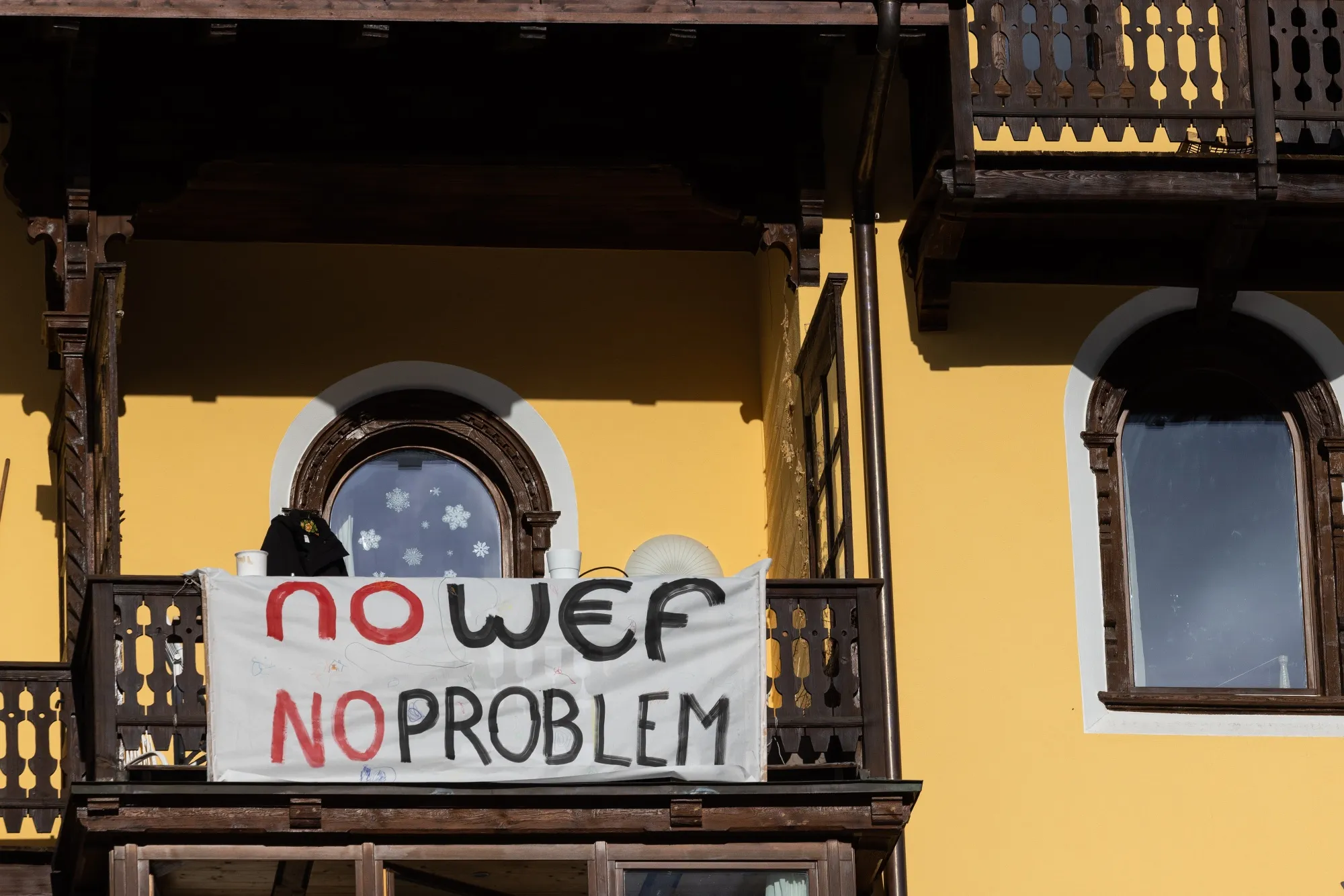 An anti-WEF banner hangs from a balcony ahead of the World Economic Forum in Davos, Switzerland.