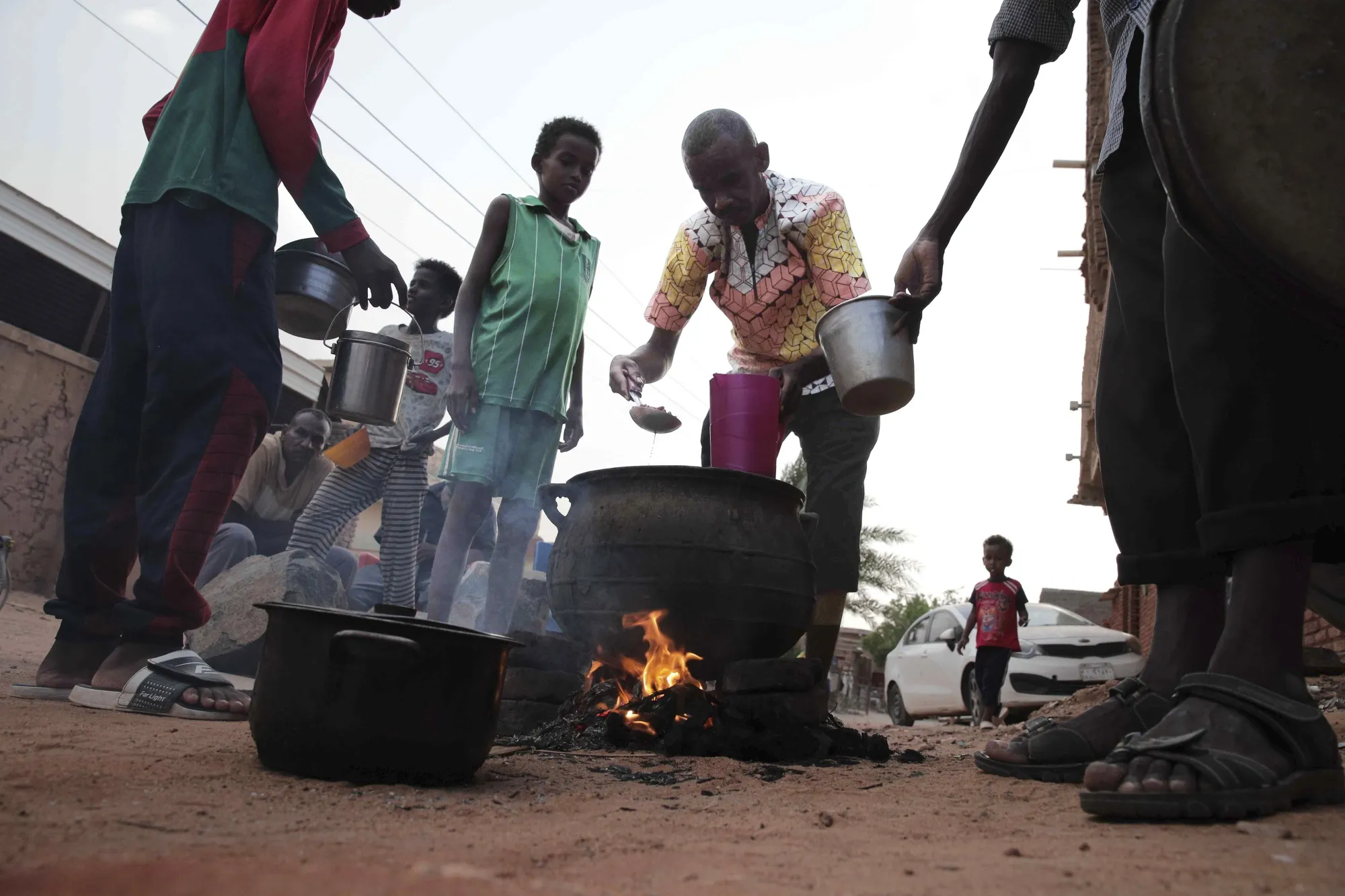 People prepare food in a Khrtoum.
