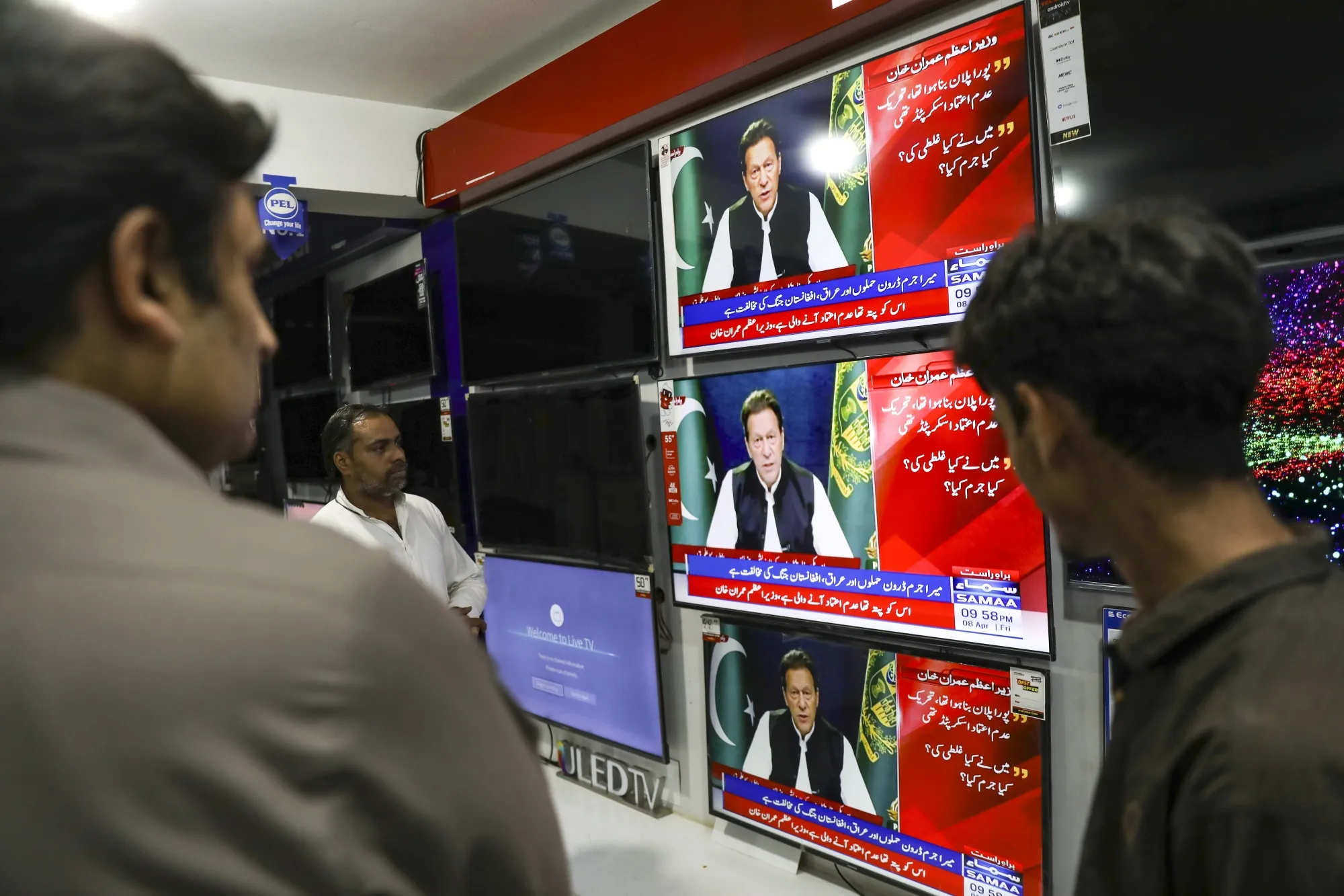 Televisions broadcast live footage of Imran Khan in Rawalpindi, Pakistan, on April 8.