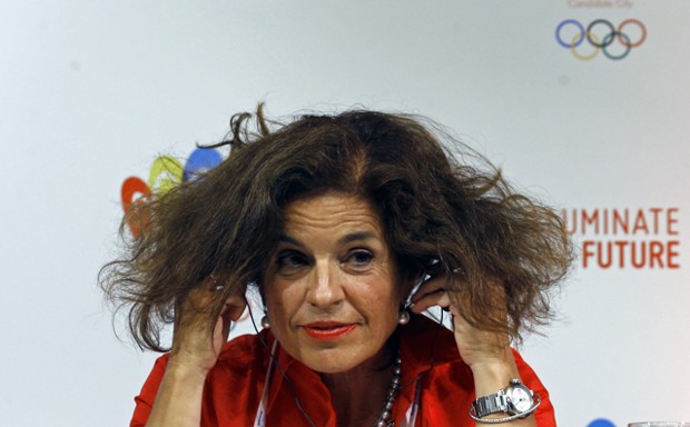Madrid Mayor Ana Botella adjusts her headphones during a news conference. 