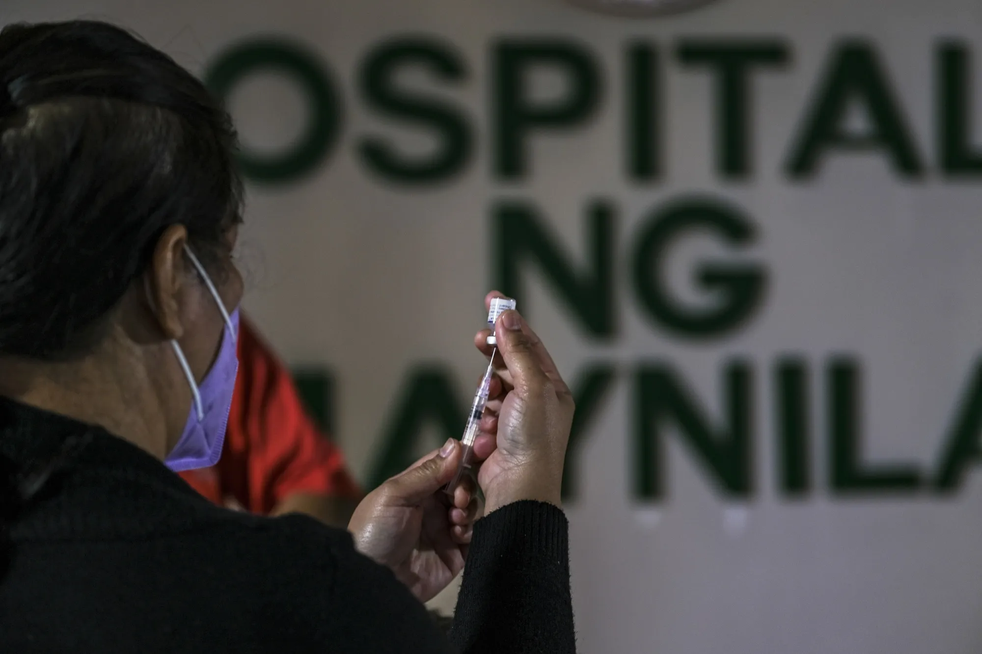 A healthcare worker administers the Covid-19 vaccine at a hospital in Manila on Nov. 9.