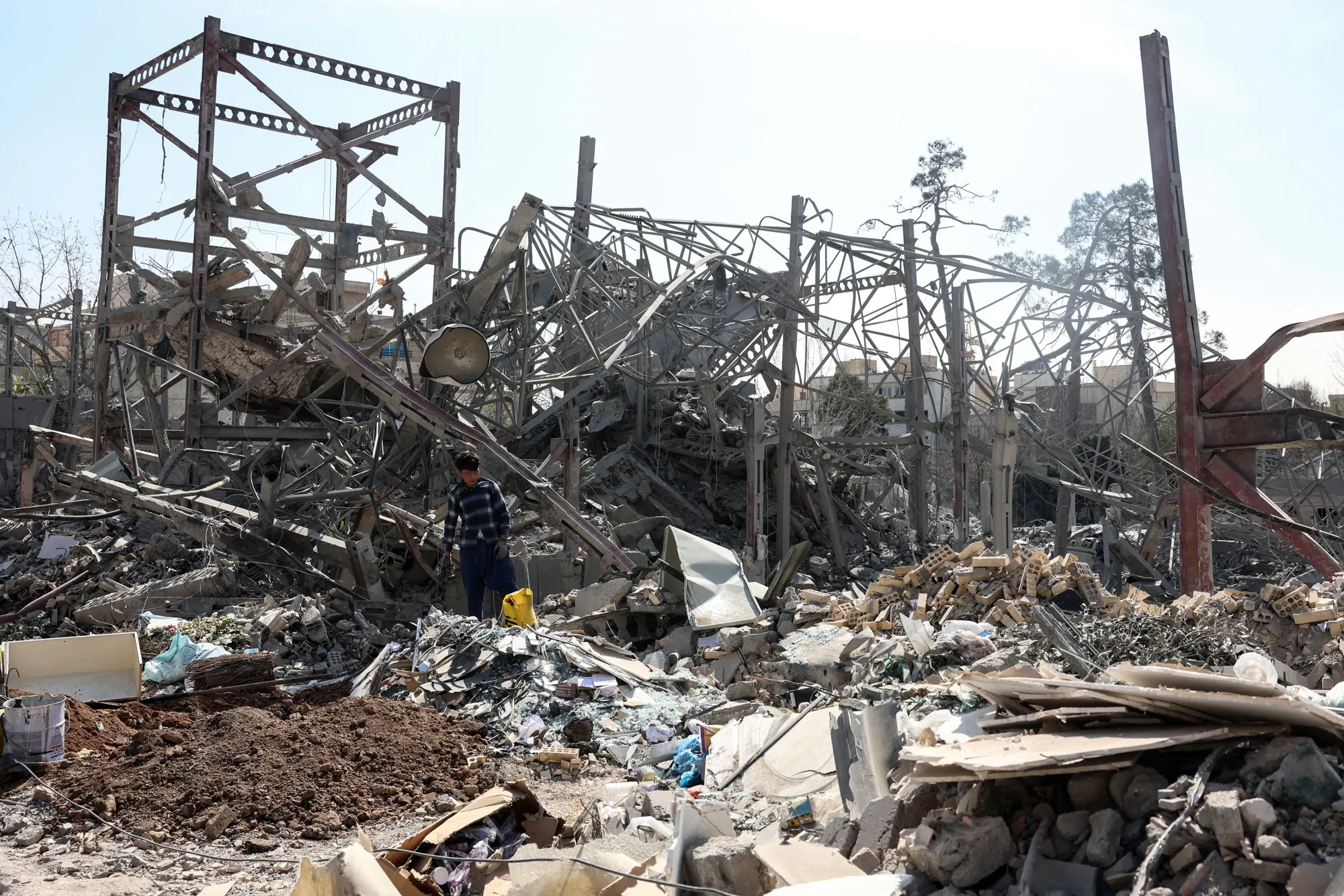 A worker clears debris following a strike on a police station in central Tehran, on March 4
