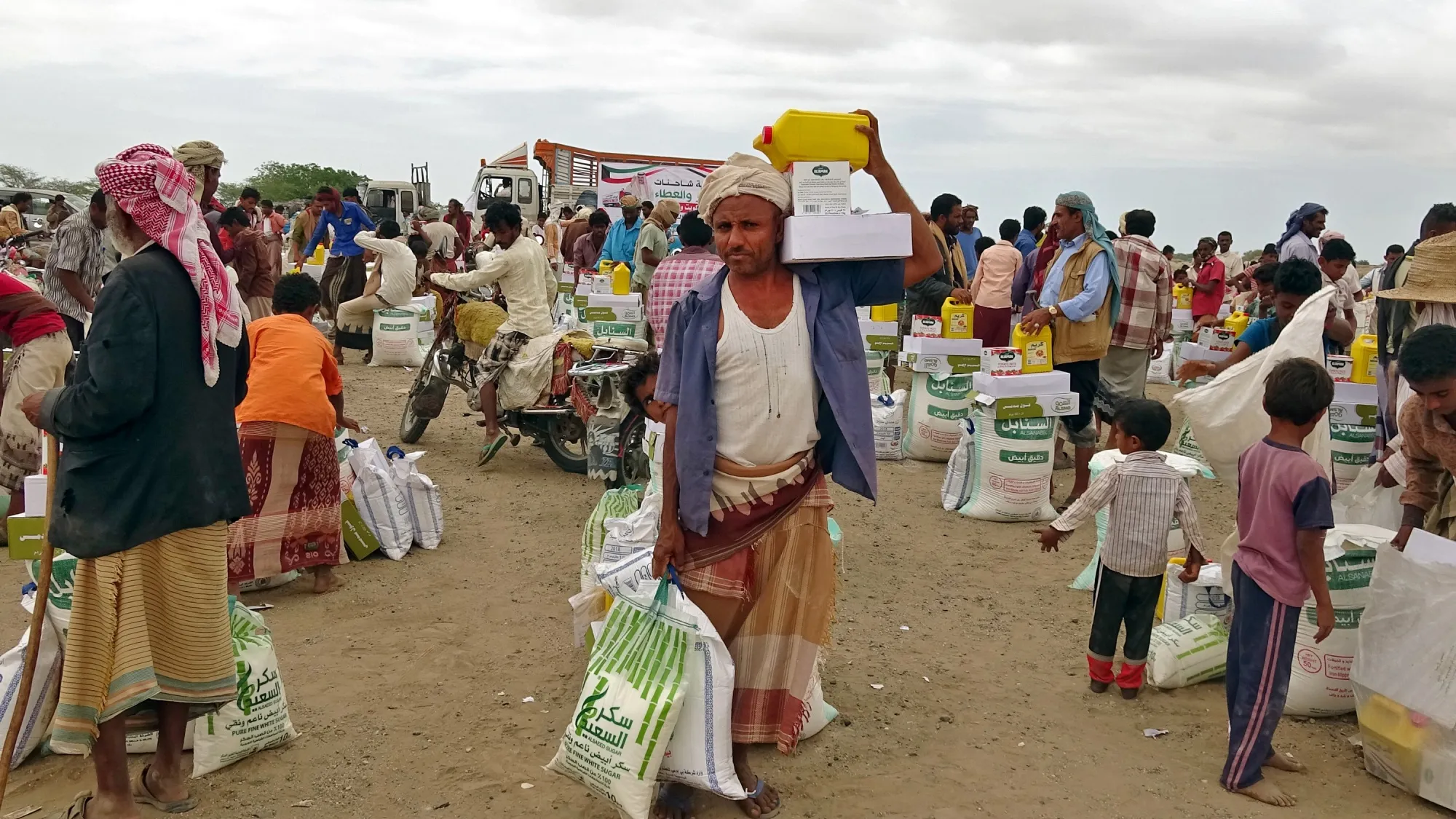 People displaced by conflict receive food aid&nbsp;near the conflict zone in Yemen's western province of Hodeida.