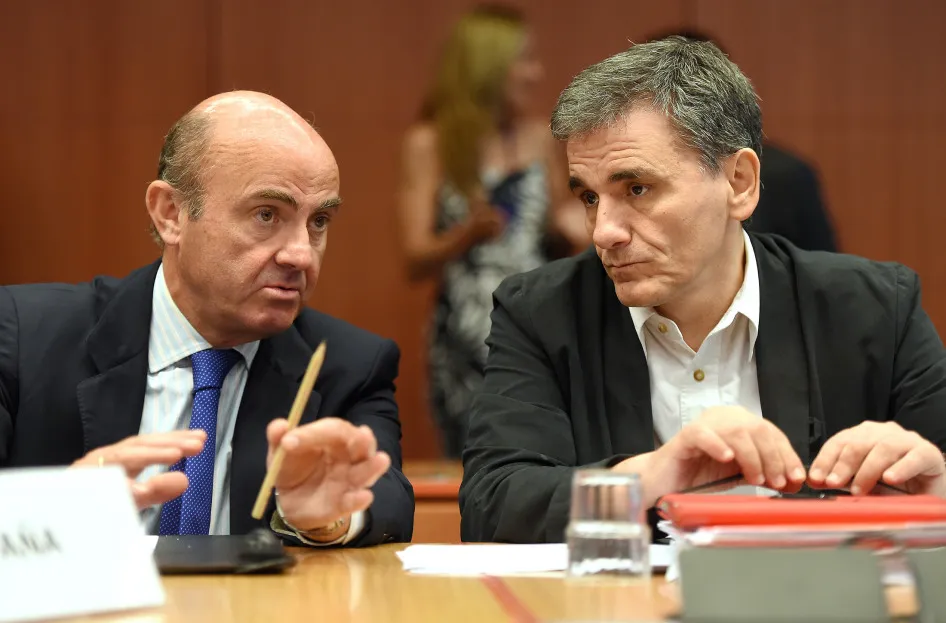 Greece's Finance Minister Euclid Tsakalotos (R) and Spanish Finance Minister Luis de Guindos Jurado talk during an Eurogroup meeting at the EU headquarters in Brussels, on Aug. 14.
