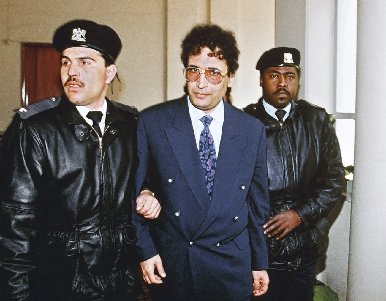Abdel Basset Ali al-Megrahi, center, is escorted to court for a hearing in Tripoli in Feb.&nbsp;1992.