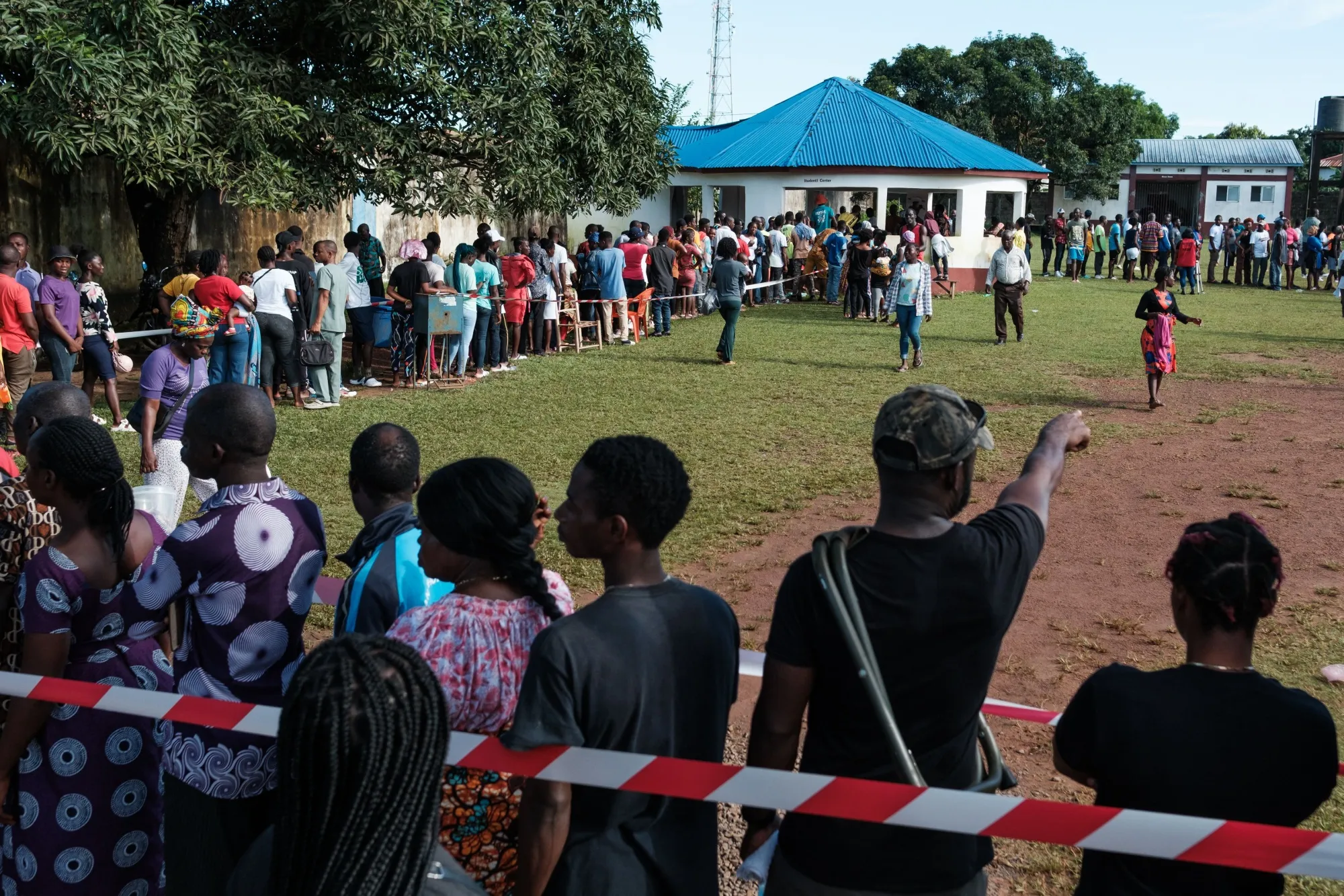 People queue outside a voting station in Kenny Town, Monrovia, Liberia.