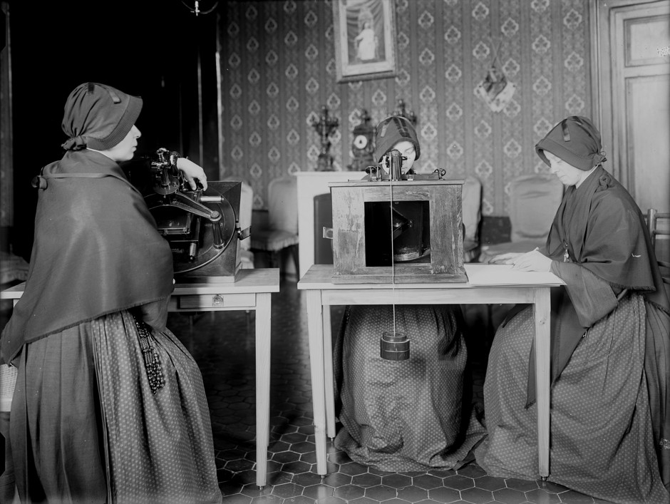 Nuns inspect glass plates as they measure star positions, as part of the Vatican's contribution to the Carte du Ciel.