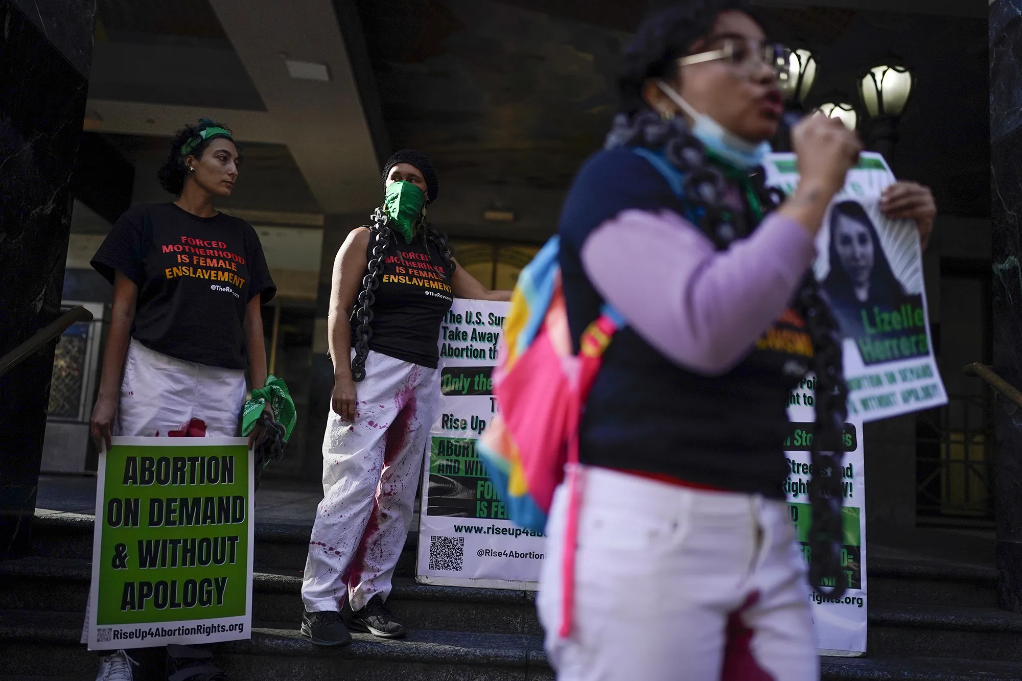 Abortion-rights advocates hold signs during a protest in support of Lizelle Herrera in Los Angeles, on April 14.
