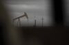 A horizontal drilling rig and a pump jack sit on federal land in Lea County, New Mexico, U.S., on Thursday, Sept. 10, 2020.