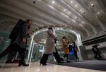 Visitors walk past an electronic ticker standing above the trading floor at the Tokyo Stock Exchange (TSE), operated by Japan Exchange Group Inc. (JPX), in Tokyo, Japan