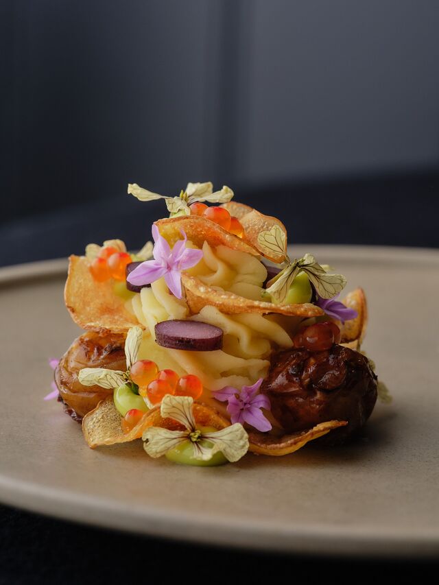 A plate of potato with artichoke and caviar prepared in various forms at O.MY.