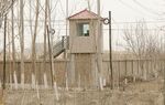 A security guard watches from a guard tower around a detention facility in Yarkent County, in northwestern China's Xinjiang Uyghur Autonomous Region on March 21, 2021.&nbsp;