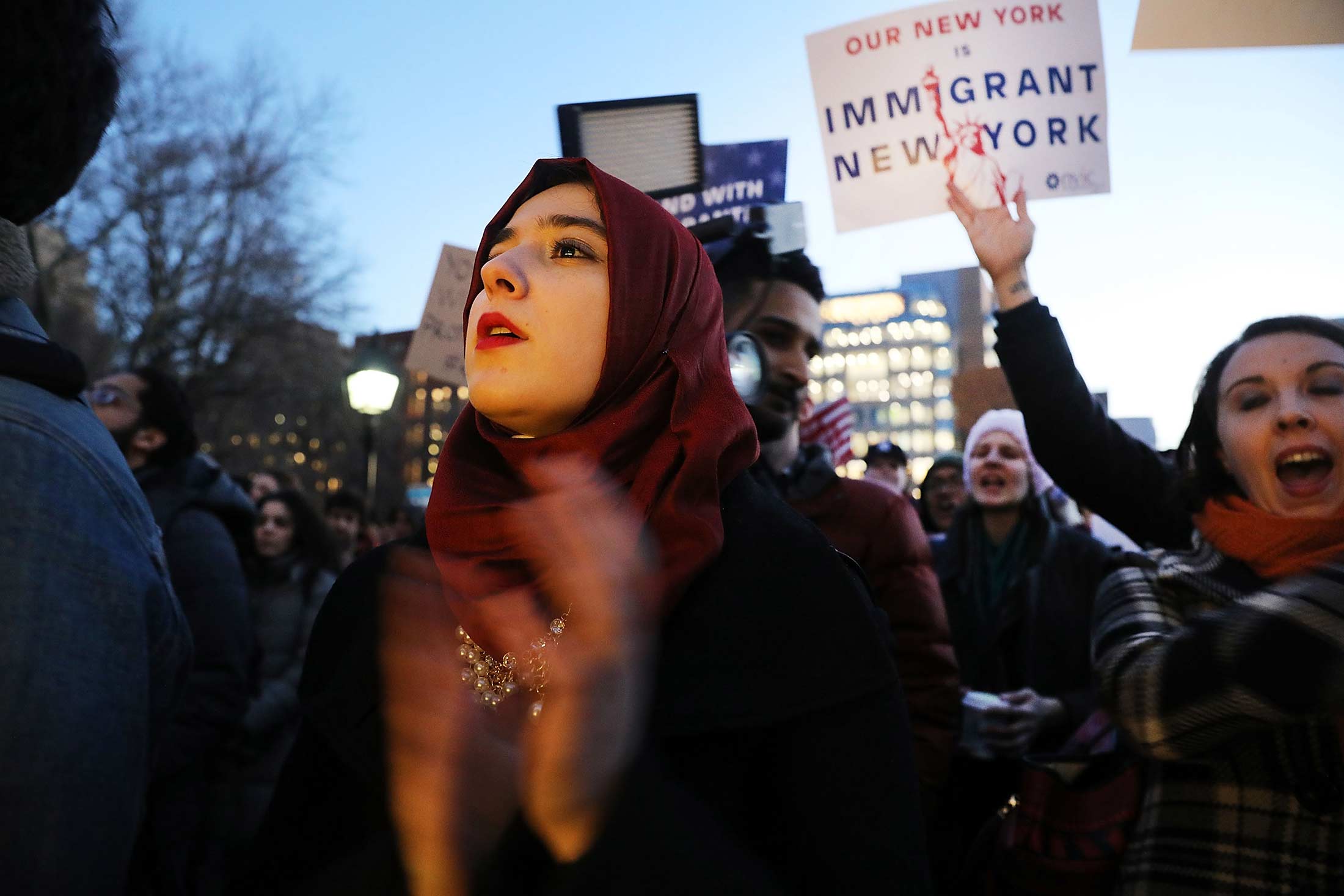 Hundreds of people attend an evening rally at Washington Square Park in New York in support of Muslims, immigrants and against the building of a wall along the Mexican border.
