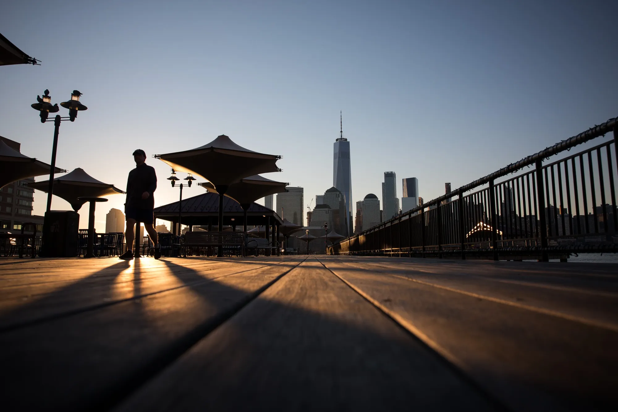 A pedestrian walks through J. Owen Grundy Park in Jersey City, New Jersey.