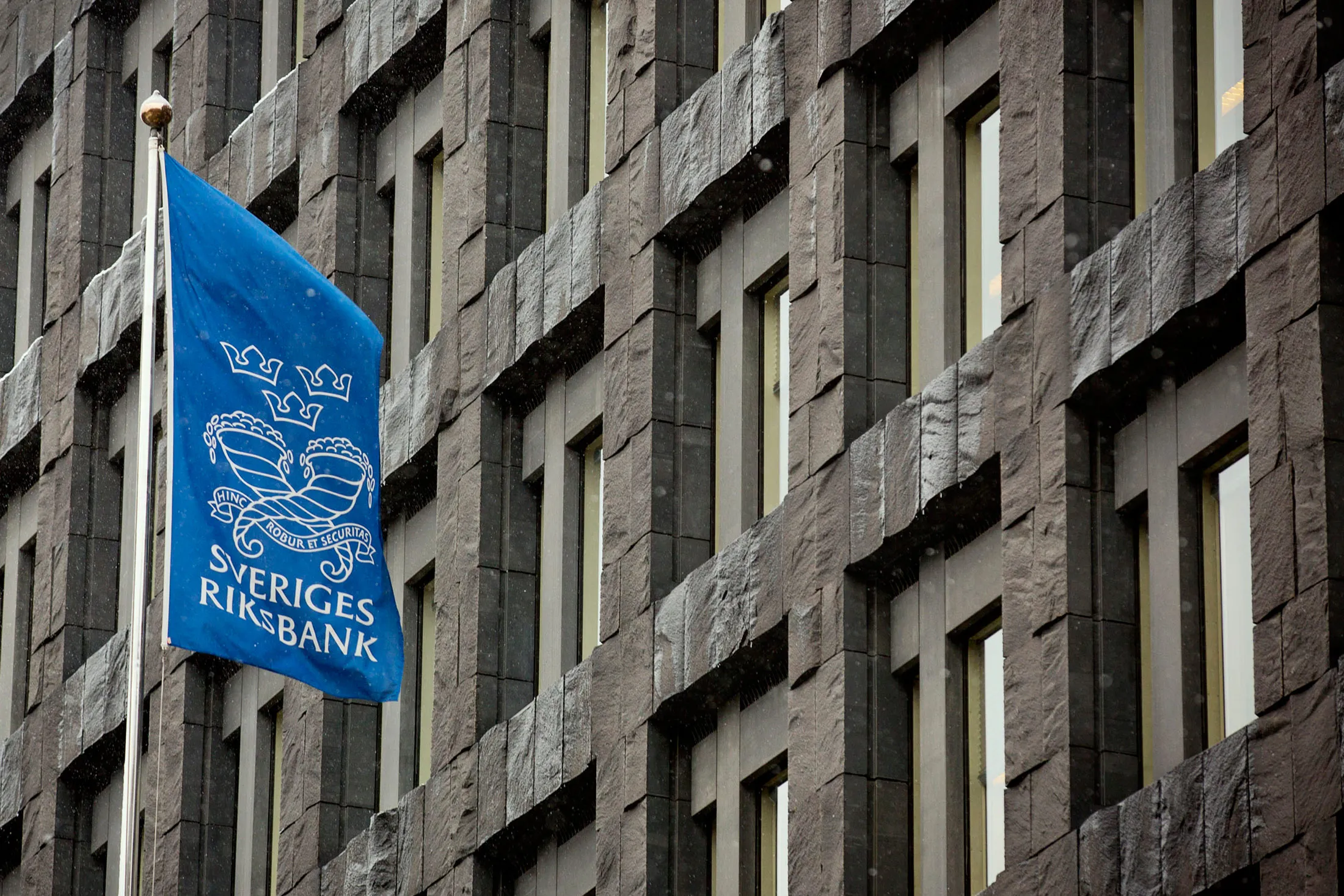 A flag flies outside the headquarters of the Riksbank, Sweden's central bank, in Stockholm.
