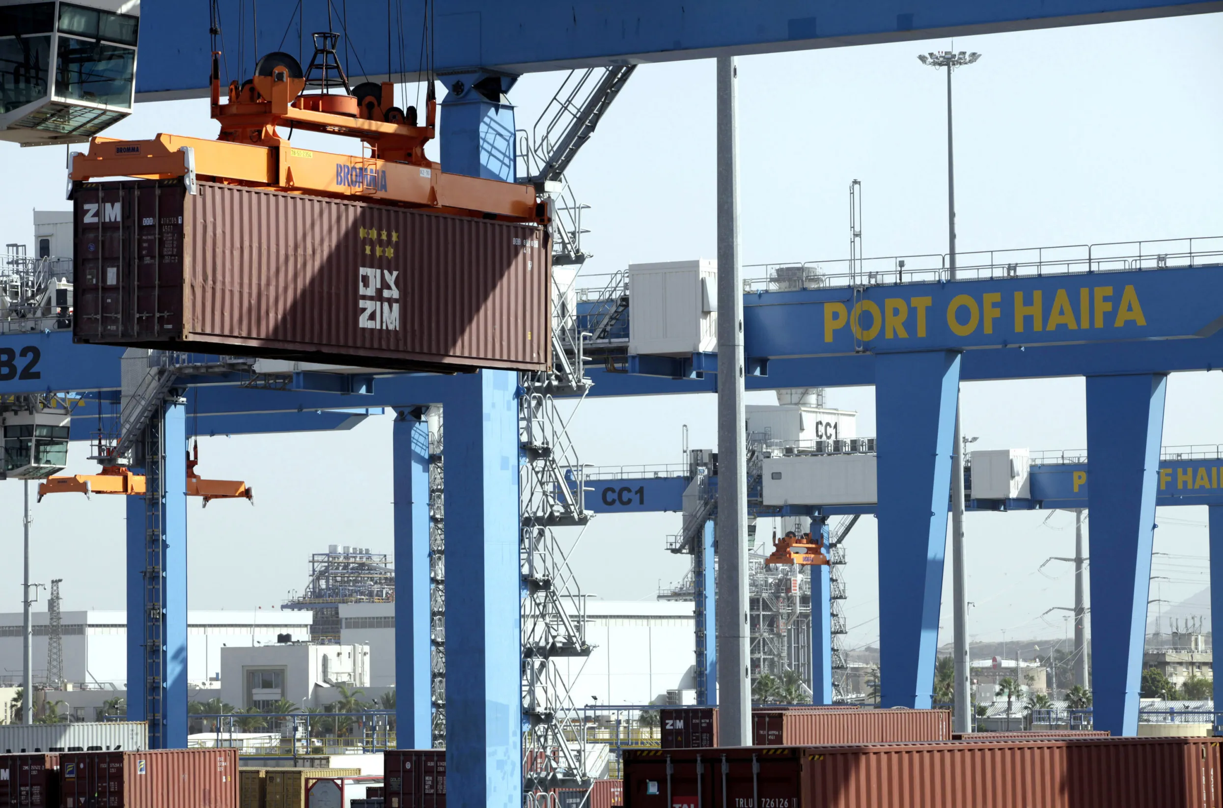 Crane carrying a shipping container at the Port of Haifa.