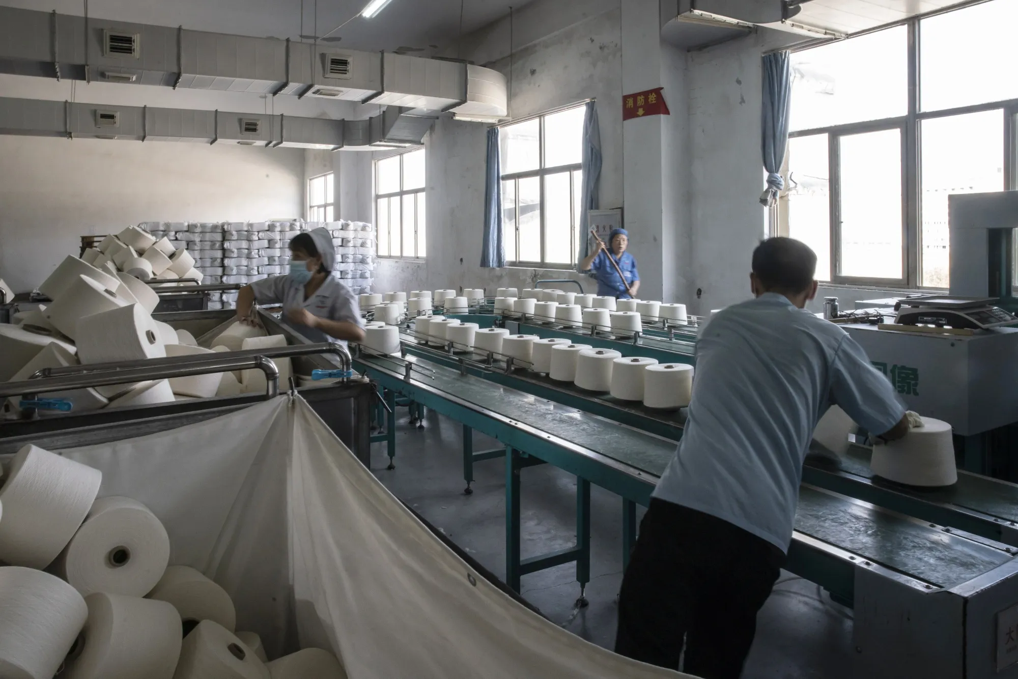 Inside a Textile Factory As China's Factories Roll on, Upending New Year’s Spending Patterns