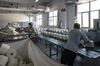 Inside a Textile Factory As China's Factories Roll on, Upending New Year’s Spending Patterns
