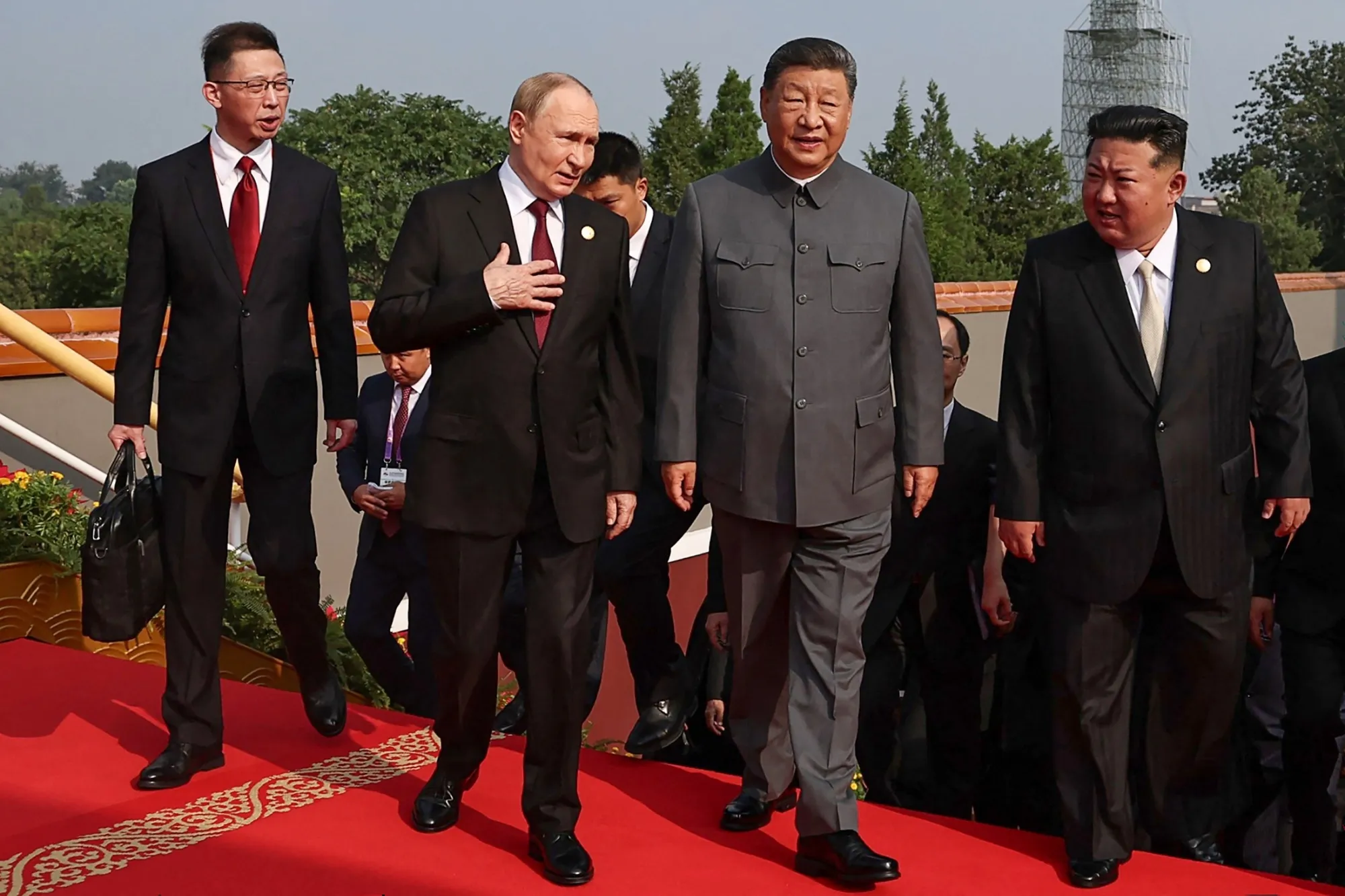 Photo of Vladimir Putin, Xi Jinping and Kim Jong Un walking together at an event commemorating the end of World War II.