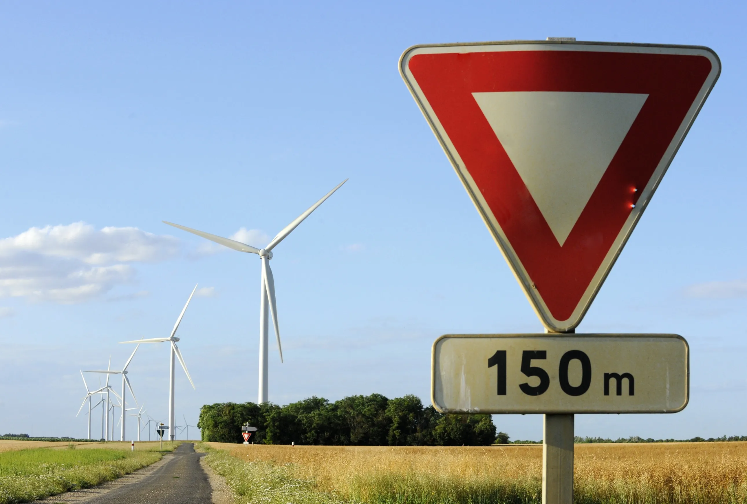 Wind turbines operate behind a road sign in Lethuin.