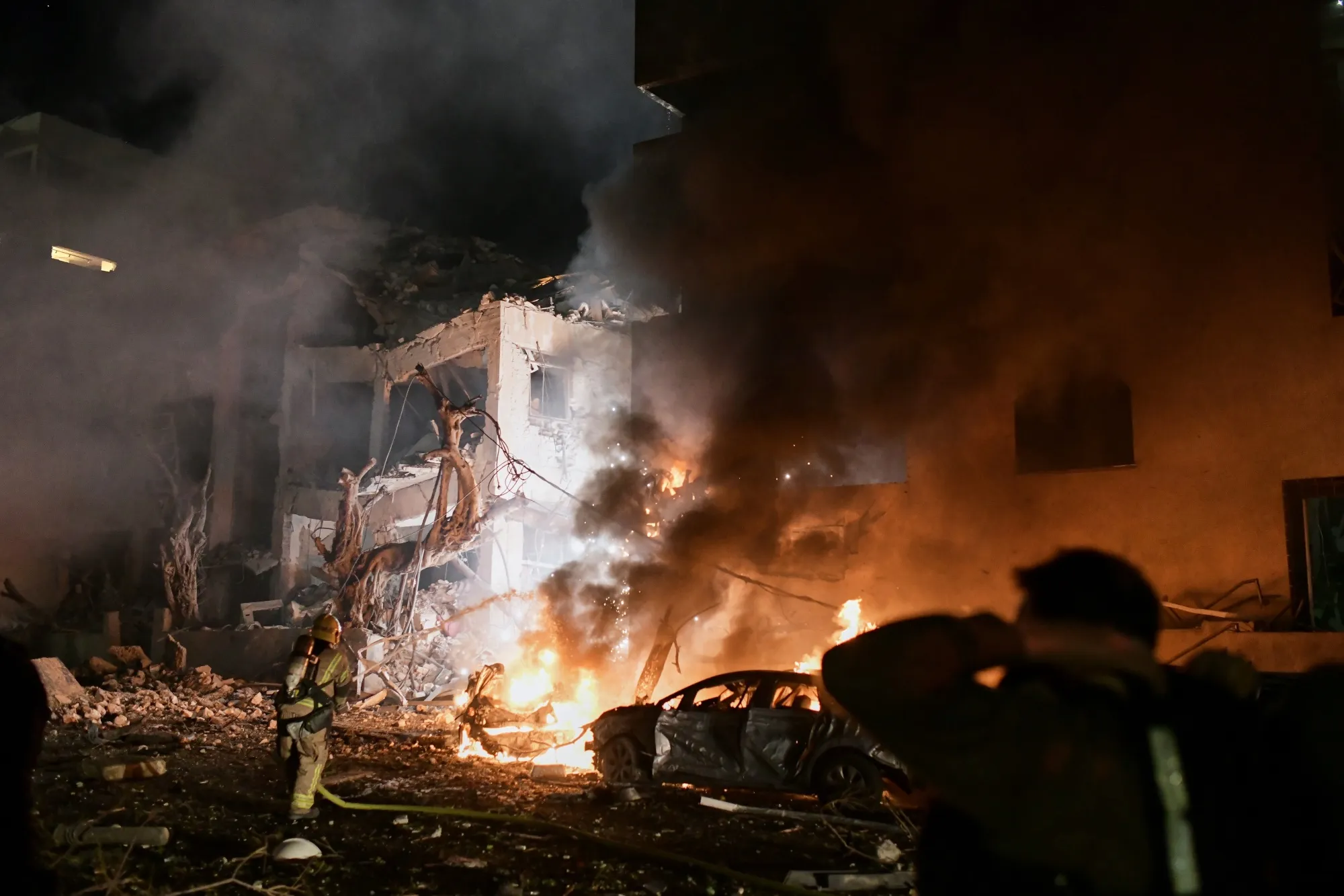 Firefighters tackle a blaze following an Iranian strike in Tel Aviv, on Feb. 28.
