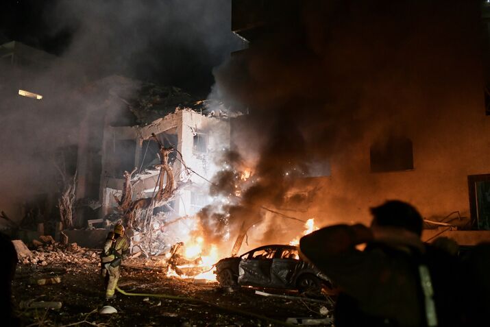 Firefighters tackle a blaze following an Iranian &nbsp;strike in Tel Aviv, on Feb. 28.