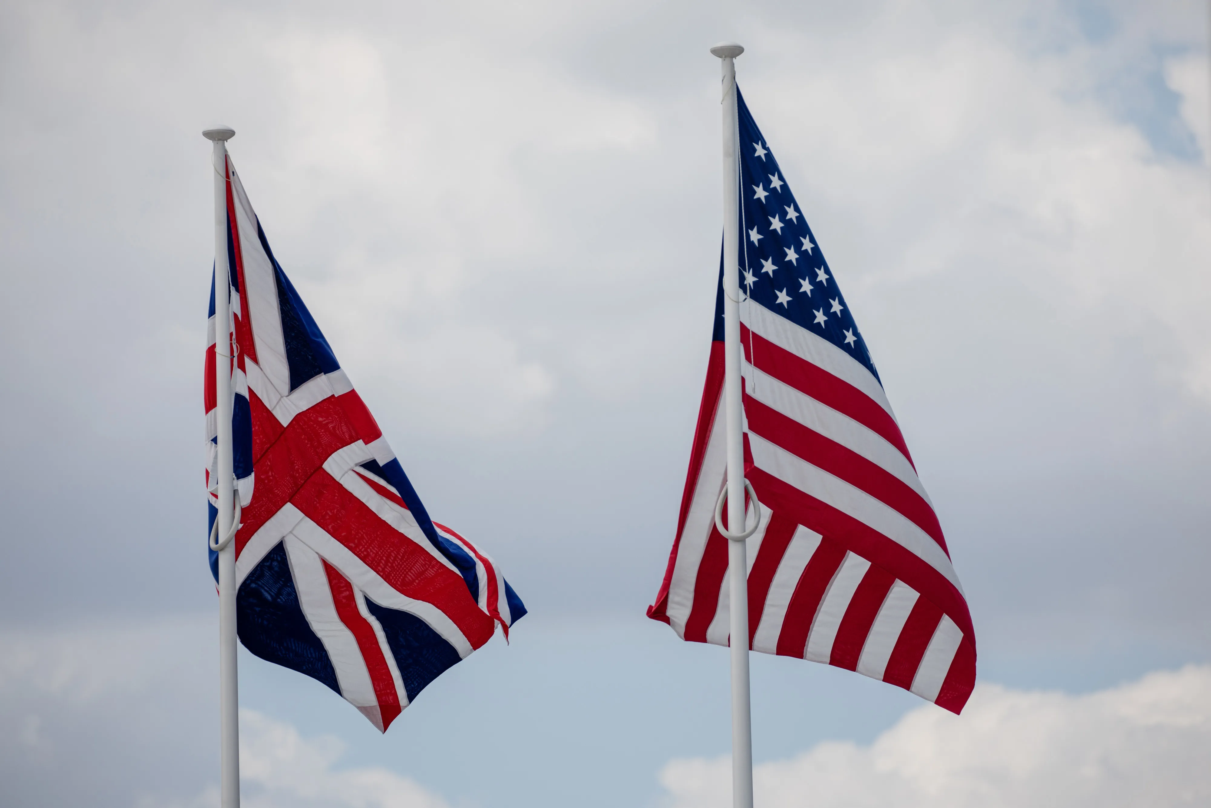 A British Union flag, also known as the Union Jack, left, flies beside a U.S. national flag&nbsp;