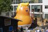 The Trump Baby sitting team give the six metre high inflatable TrumpBaby his first London outing inside the disused North London playground, Islington, London.