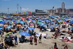 Beachgoers spend their day in the hot weather at Coney Island in New York.