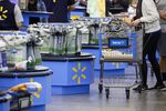 A customer pushes a shopping cart at a Walmart store in Burbank, California.