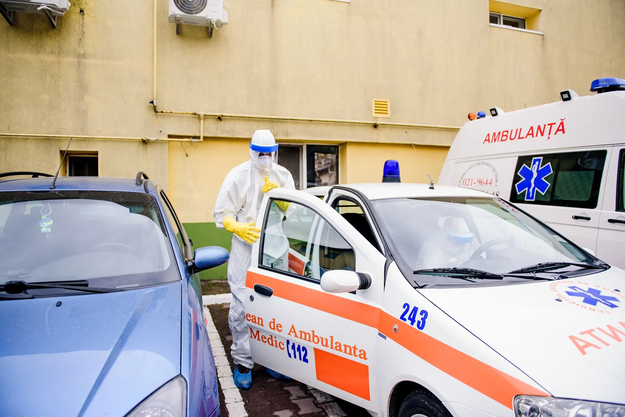 Health workers in hazmat suits get into an ambulance before visiting self-isolated patients in Bucharest on March 10.