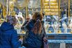 Shoppers look at gold jewelry for sale in a store window at the Grand Bazaar in Istanbul