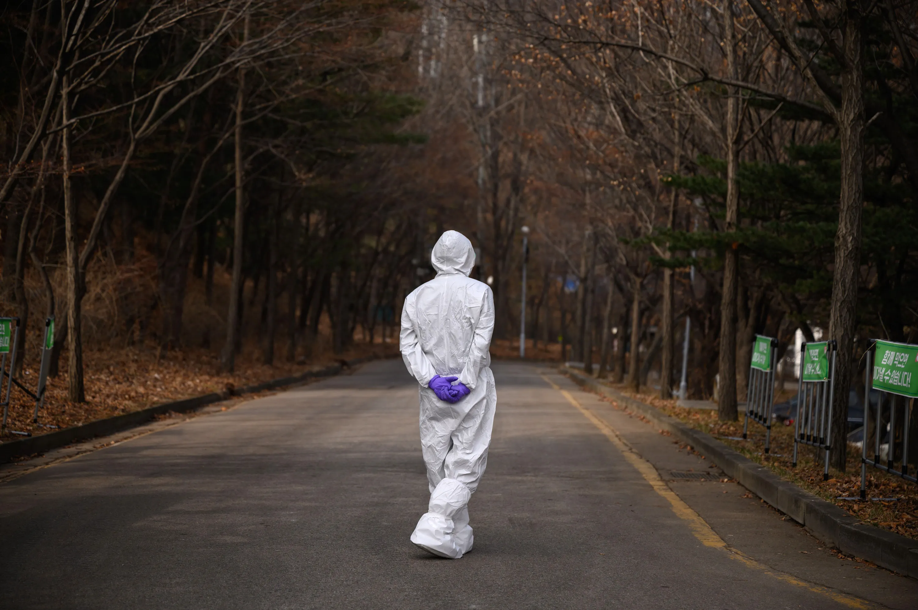 A health worker wearing a protective suit waits at a drive-through testing center&nbsp;for the Covid-19 coronavirus in Seoul, on March 7.