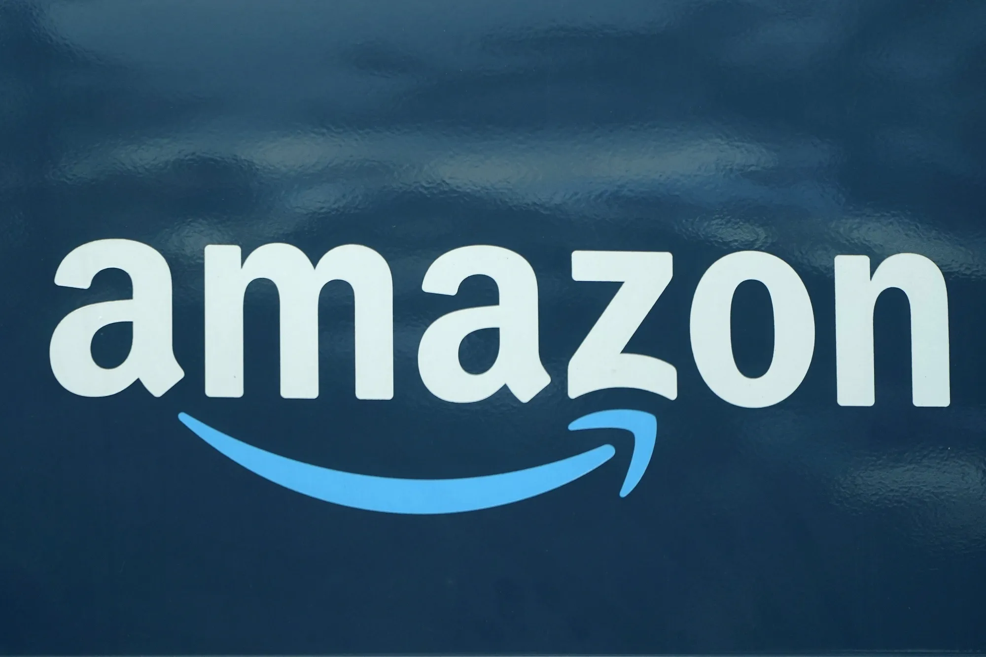 An Amazon logo appears on an Amazon delivery van, on Oct. 1, 2020, in Boston. Amazon announced Thursday, March 17, 2022 it has closed its acquisition of Hollywood studio MGM two days after European regulators said the deal “would not significantly reduce competition” in European markets. MGM is one of the oldest studios in Hollywood. (AP Photo/Steven Senne, File)