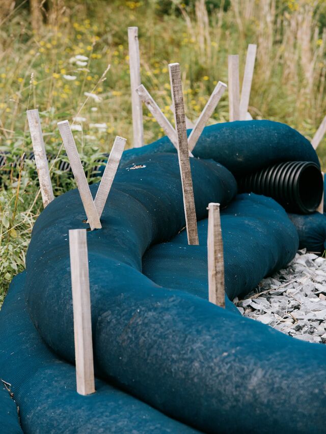 Lindside, WV (Monroe County) New silt socks are staked into the ground near a slope.