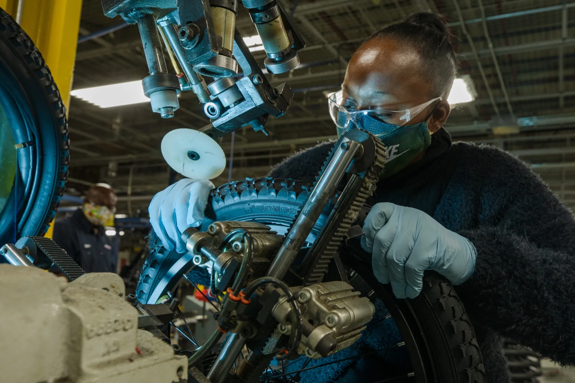 A employee inspects a tire at a bicycles production facility in Manning, South Carolina.