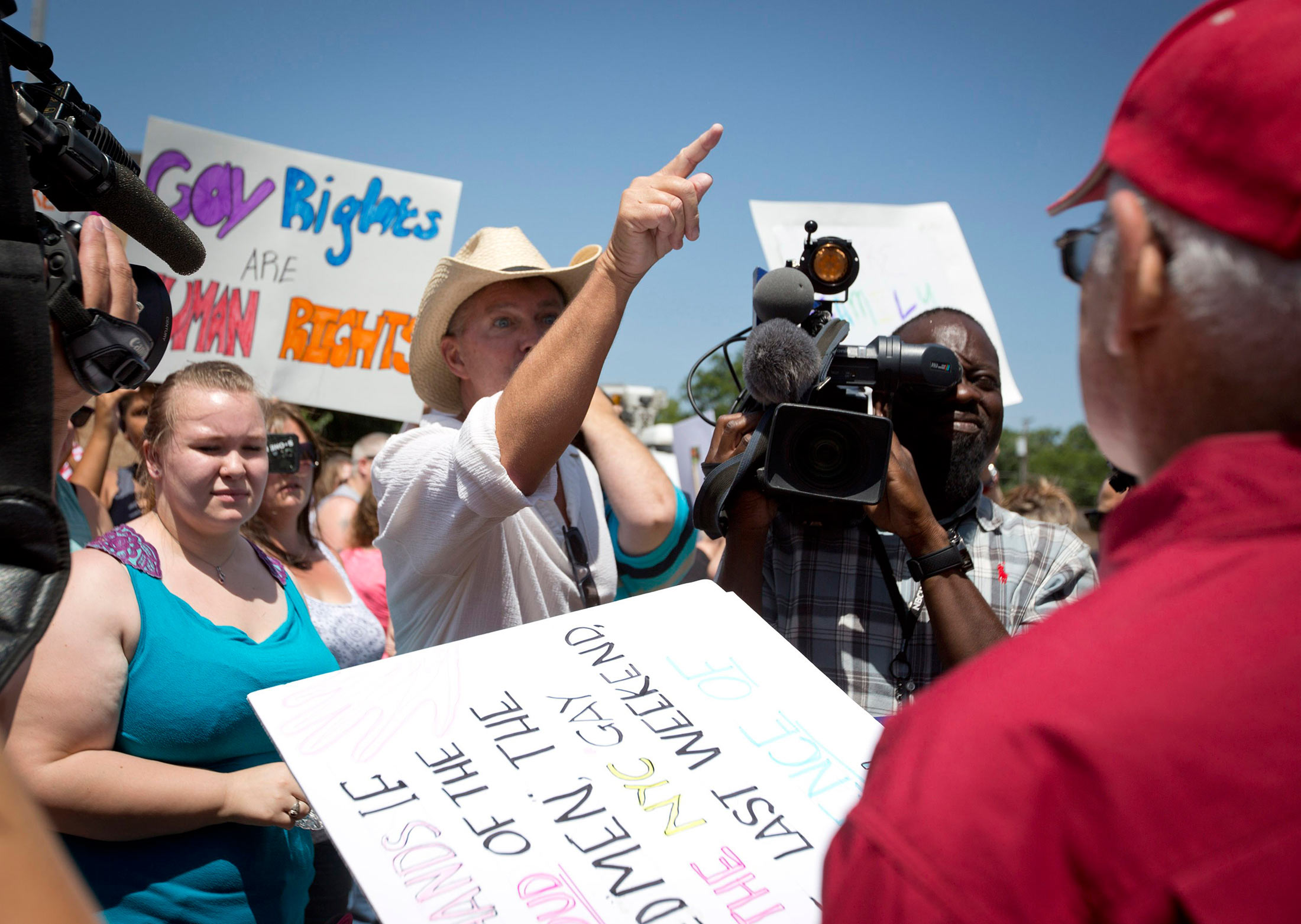 Joe Stapleton, center, and Neill Wilkerson, right, exchange words during at the courthouse in Granbury, Texas, on Thursday, July 2, 2015, amid dueling same-sex marriage rallies.
